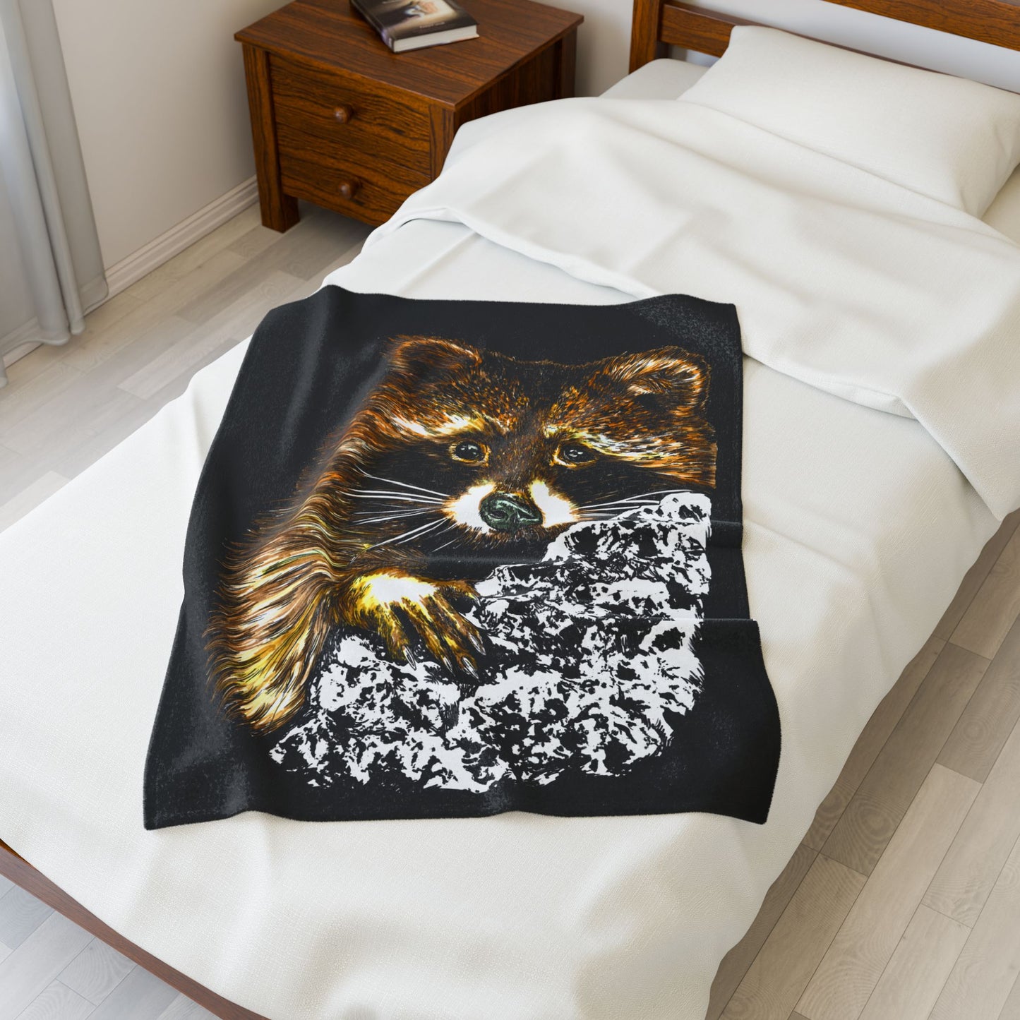 Cozy Raccoon Velveteen Plush Blanket on a bed, perfect for animal lovers and chilly evenings.