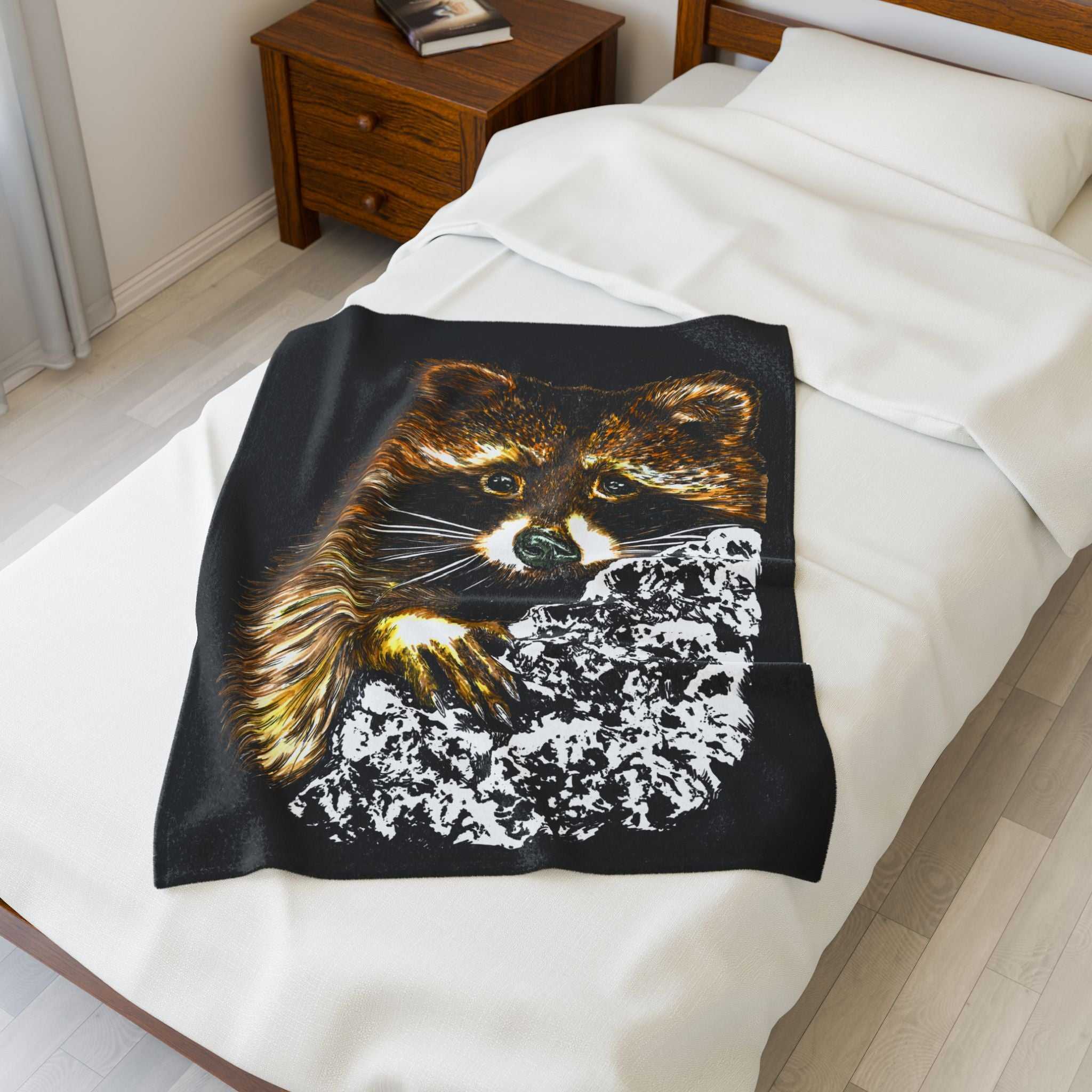 Cozy Raccoon Velveteen Plush Blanket on a bed, perfect for animal lovers and chilly evenings.