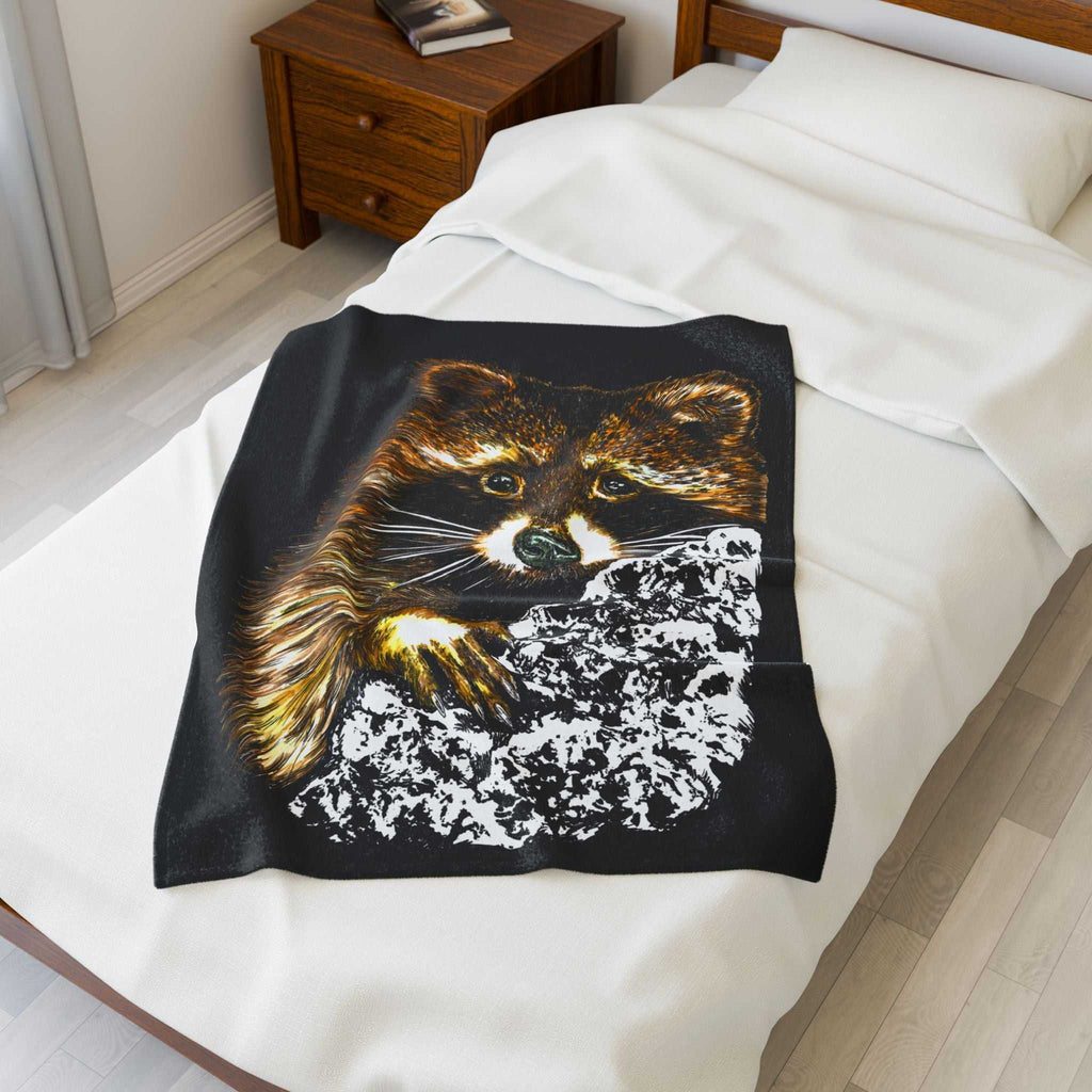 Cozy Raccoon Velveteen Plush Blanket on a bed, perfect for animal lovers and chilly evenings.